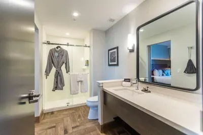a bathroom with a sink and a toilet and a mirror at Hotel Rock Lititz in Lititz