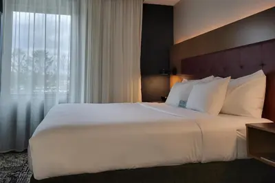 a large white bed in a hotel room with a window at Hotel Rock Lititz in Lititz