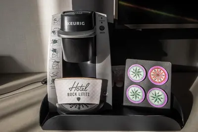 a coffeemaker with a kiwi new unit on a table at Hotel Rock Lititz in Lititz