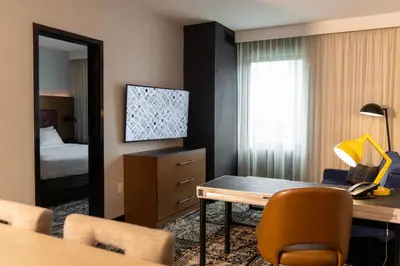 a hotel room with a desk and a bedroom at Hotel Rock Lititz in Lititz