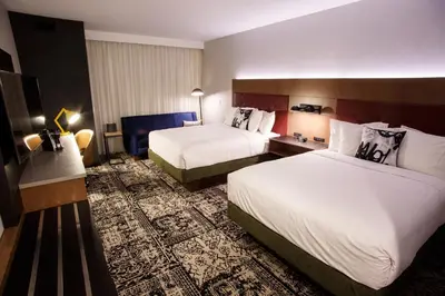 a hotel room with two beds and a desk at Hotel Rock Lititz in Lititz
