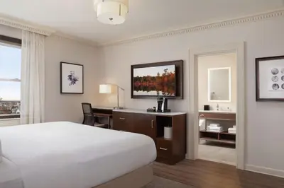 a hotel room with a bed and a desk with a computer at The Albion Summit in Summit