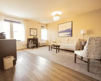 a living room with a couch and a table at The Albion Summit in Summit