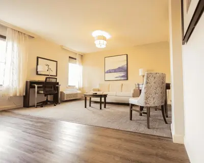 a living room with a couch and a table at The Albion Summit in Summit