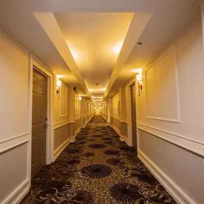 an empty hallway with a long corridor with yellow ceilings at The Albion Summit in Summit