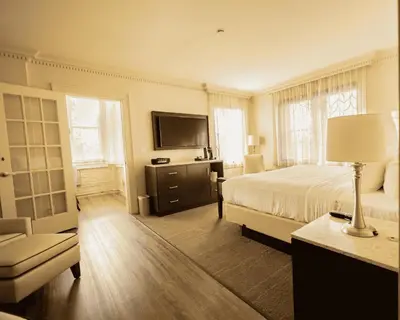 a bedroom with a bed and a television and a couch at The Albion Summit in Summit