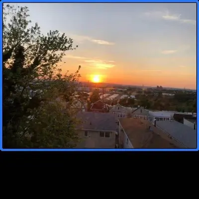 a sunset over a city with the sun in the sky at Business & Family Friendly Balcony Jacuzzi Free Park in Jersey City