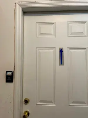 a white door with a blue arrow on it at Business & Family Friendly Balcony Jacuzzi Free Park in Jersey City