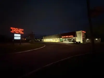 a building with neon signs on it at night at Beauty Rest Hotel in Edison