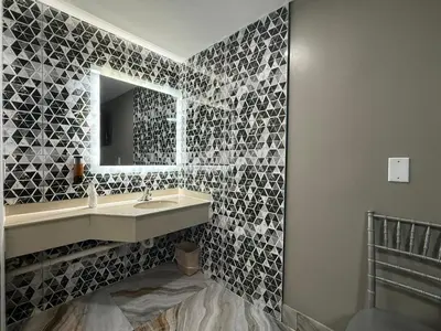 a bathroom with a sink and a mirror at Beauty Rest Hotel in Edison