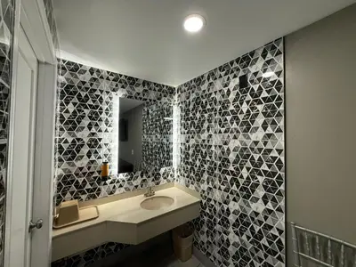 a bathroom with a sink and a mirror at Beauty Rest Hotel in Edison