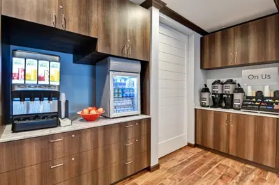 a kitchen with wooden cabinets and a counter with aasteryasteryasteryasteryasteryastery at TownePlace Suites by Marriott Bridgewater Branchburg in Branchburg Park