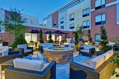 a patio with a fire pit in front of a building at TownePlace Suites by Marriott Bridgewater Branchburg in Branchburg Park