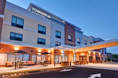 an exterior view of a hotel with tables and chairs at TownePlace Suites by Marriott Bridgewater Branchburg in Branchburg Park