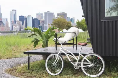 a bike parked next to a table with a bird on it at Collective Retreats Governors Island in New York