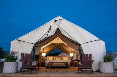a large tent with two chairs and a table at Collective Retreats Governors Island in New York