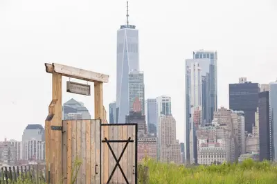 a wooden box with a city in the background at Collective Retreats Governors Island in New York