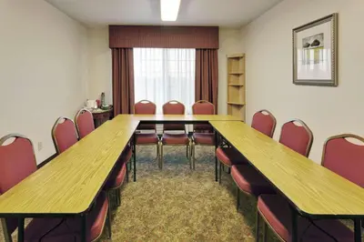 a conference room with a long table and chairs at Country Inn & Suites by Radisson, Big Flats (Elmira), NY in Horseheads