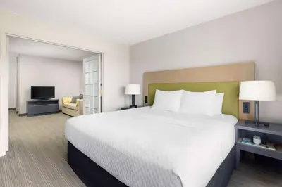 a hotel room with a large bed and a television at Country Inn & Suites by Radisson, Big Flats (Elmira), NY in Horseheads