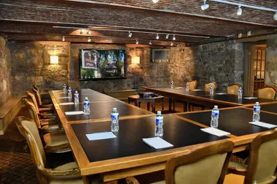 a room with tables and chairs with water bottles on them at The Sayre Mansion in Bethlehem