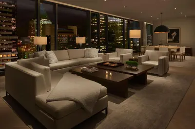 a living room with a couch and a table at The Times Square EDITION New York in New York
