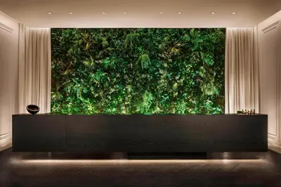 a large green wall in a room at The Times Square EDITION New York in New York