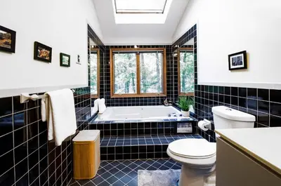 a bathroom with a tub and a toilet at Big House On The Hill in East Stroudsburg