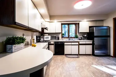 a kitchen with white cabinets and a white counter top at Big House On The Hill in East Stroudsburg