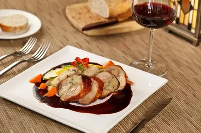 a plate of food on a table with a glass of wine at Settlers Inn in Hawley
