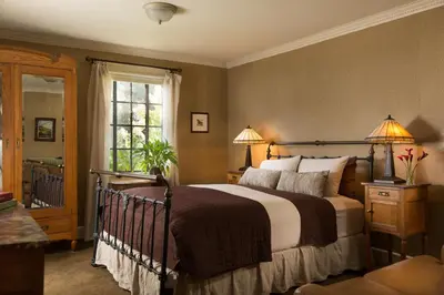 a bedroom with a bed with two lamps and a window at Settlers Inn in Hawley