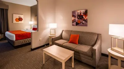 a hotel room with a couch and a bed at Best Western Plus New Cumberland in New Cumberland