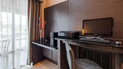 a hotel room with a desk with a computer on it at Best Western Plus New Cumberland in New Cumberland