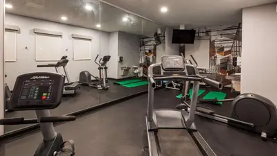 a gym with several tread machines in a room at Best Western Plus New Cumberland in New Cumberland