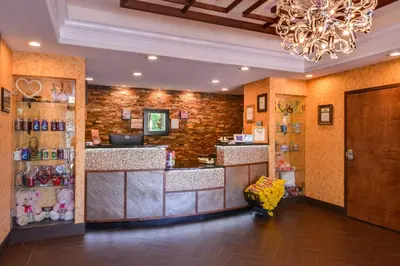 a restaurant with a counter and a chandelier at Inn of The Dove Romantic Luxury & Business Suites in Bensalem