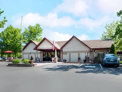 a building with a car parked in a parking lot at Inn of The Dove Romantic Luxury & Business Suites in Bensalem