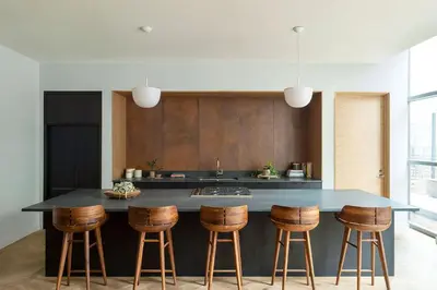 a kitchen with a island with bar stools at ROOST East Market in Philadelphia