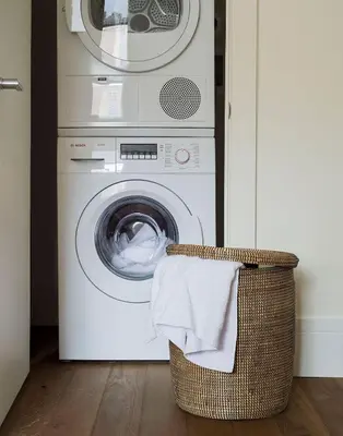 a washer and dryer in a room with a basket at ROOST East Market in Philadelphia