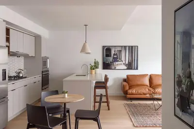 a kitchen and living room with a table and chairs at ROOST East Market in Philadelphia