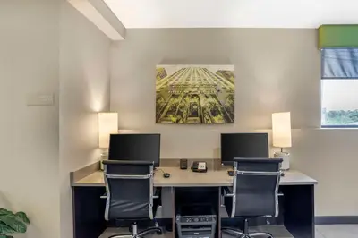 an office with a desk with two monitors and two chairs at Best Western Plus Philadelphia-Pennsauken Hotel in Cherry Hill