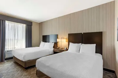 a hotel room with two beds and a window at Best Western Plus Philadelphia-Pennsauken Hotel in Cherry Hill
