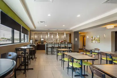 a restaurant with tables and chairs and a bar at Best Western Plus Philadelphia-Pennsauken Hotel in Cherry Hill