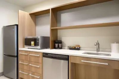 a kitchen with a stainless steel refrigerator and a sink at Home2 Suites By Hilton Warminster Horsham in Warminster