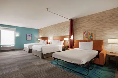 a hotel room with two beds and a desk at Home2 Suites By Hilton Warminster Horsham in Warminster