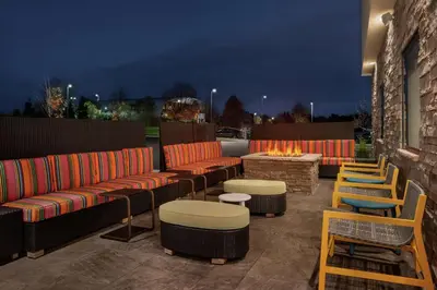 a patio with couches and chairs and a fire pit at Home2 Suites By Hilton Warminster Horsham in Warminster