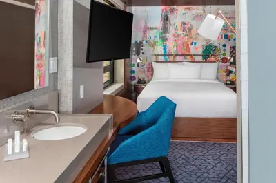a bathroom with a sink and a bed in a room at SpringHill Suites by Marriott New York Manhattan/Times Square South in New York