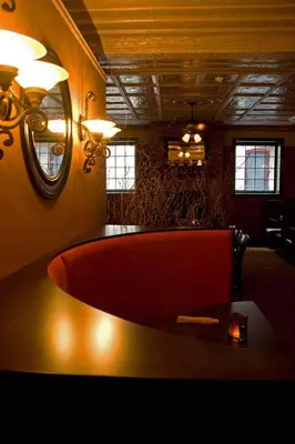 a large red tub in a room with a mirror at The Inn at Jim Thorpe in Jim Thorpe