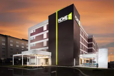 a hotel with a sign on the side of a building at Home2 Suites By Hilton Newark Airport in Newark