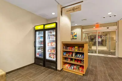 a grocery store aisle with a refrigerator and drinks at Home2 Suites By Hilton Newark Airport in Newark