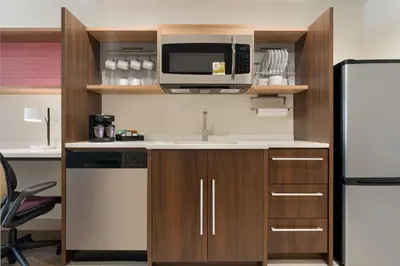a kitchen with a sink and a refrigerator at Home2 Suites By Hilton Newark Airport in Newark