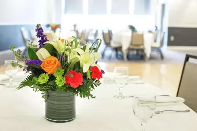 a vase filled with flowers sitting on a table at Hilton Newark Airport in Elizabeth
